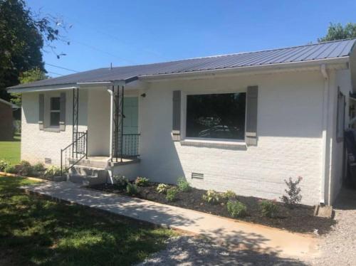 a small white house with a window on it at 3 Bedroom Cozy Home Minutes From Tims Ford Lake in Winchester