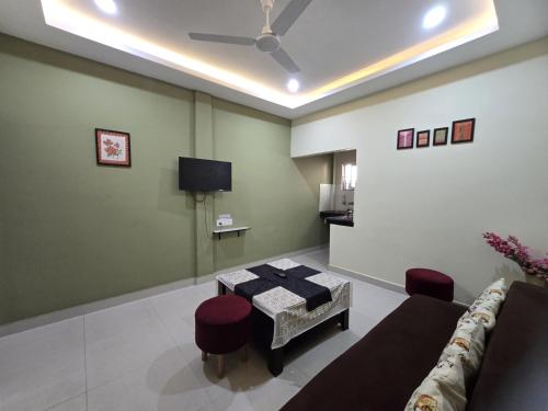a living room with a couch and a table at The Gulmohar Inn in Guwahati
