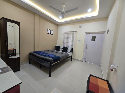 a bedroom with a bed in a room with a ceiling at The Gulmohar Inn in Guwahati