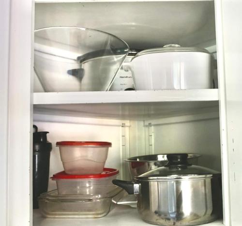 a cabinet filled with lots of pots and pans at University Place-near U Of U, Hospitals, Downtown in Salt Lake City