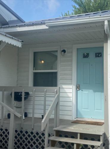a front porch of a house with a blue door at Newly Renovated Cozy Place Minutes From The Lake in Winchester