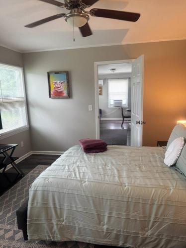 a bedroom with a bed and a ceiling fan at Newly Renovated Cozy Place Minutes From The Lake in Winchester