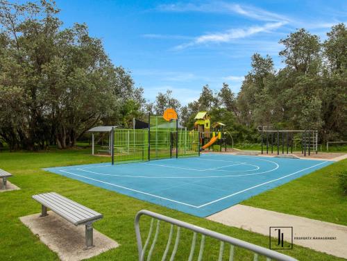 a tennis court in a park with a playground at Coastal Escape - walking distance to beach pet friendly in Long Beach