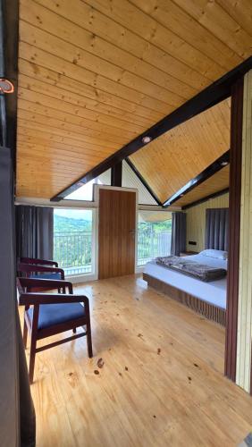 a bedroom with a bed and a bench in a room at Rosewood Cottage in Mukteshwar