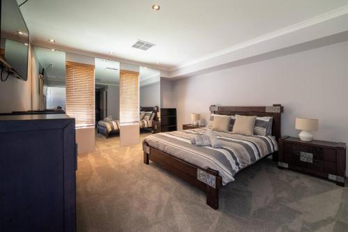 a bedroom with a bed and a living room at 13 Home Close To Swan Valley In Brabham in Henley Brook