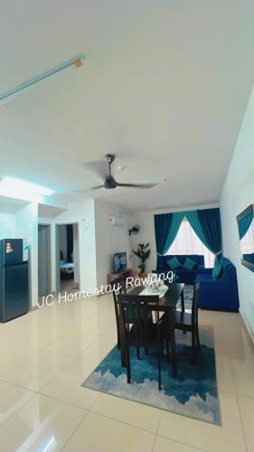 a dining room and living room with a table and a couch at JC HOMESTAY PARADiSE in Rawang
