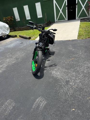 a motorcycle is parked in a parking lot at Olive Studio Apart Unit 2 By Pmi in West Palm Beach