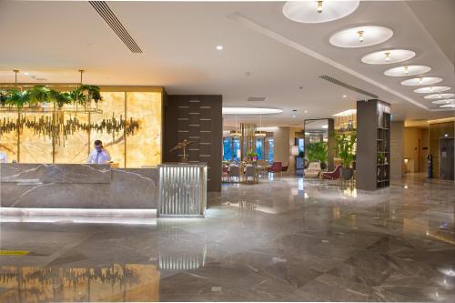 a lobby with a reception desk in a building at Miramare Beach Hotel - Ultra All Inclusive in Side