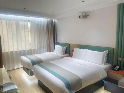 a hotel room with two beds in a room at Beijing Inner Mongolia Hotel Chaoyang in Beijing