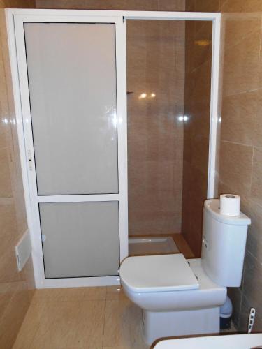 a bathroom with a white toilet and a shower at Boutique Hôtel Albaraka in Dakhla