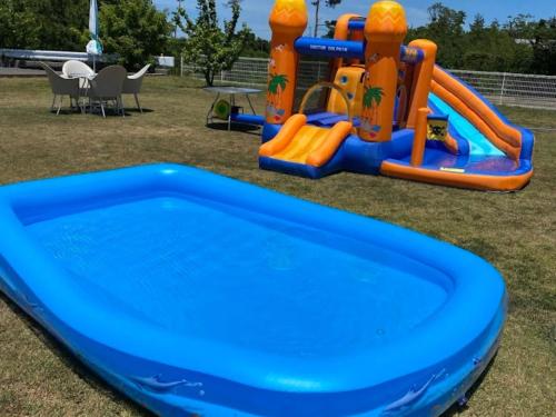 a blue and orange inflatable water slide in a park at Ikoi no mura Notohanto in Shika