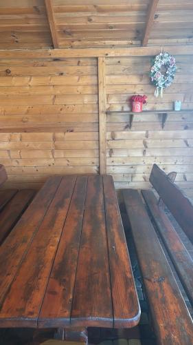 a wooden bench in a room with a wooden wall at Apartament u Moni in Krajno Pierwsze
