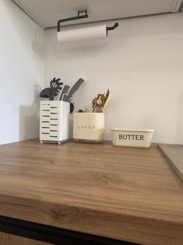 a kitchen counter with two containers of utensils on it at Apartament u Moni in Krajno Pierwsze