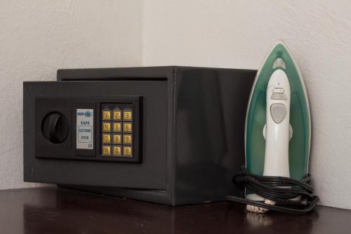 a remote control sitting inside of a black microwave at HG Hotel in Guadalajara