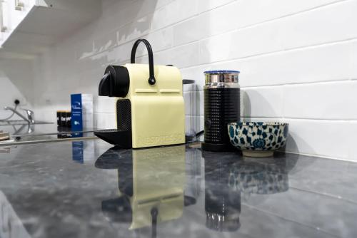 a yellow suitcase sitting on top of a counter at Blue Door Apartment 2 - CBD, Heritage, Ideal for Work in Orange