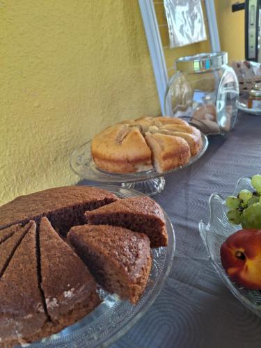 a table topped with two plates of cakes and fruit at Agriturismo Podere 329 in Magliano in Toscana