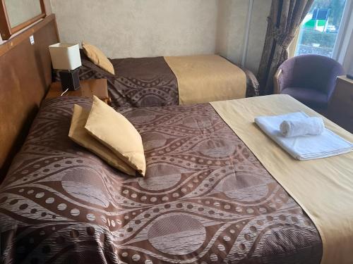Ένα ή περισσότερα κρεβάτια σε δωμάτιο στο OYO Baytree Lodge