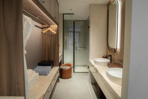a bathroom with two sinks and a shower at Richmann Resort Hotel Hatyai in Hat Yai