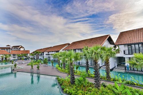 an image of the courtyard of a resort with palm trees at Bertam Wellness Spa & Villas - A Member of Small Luxury Hotels of the World in Kepala Batas