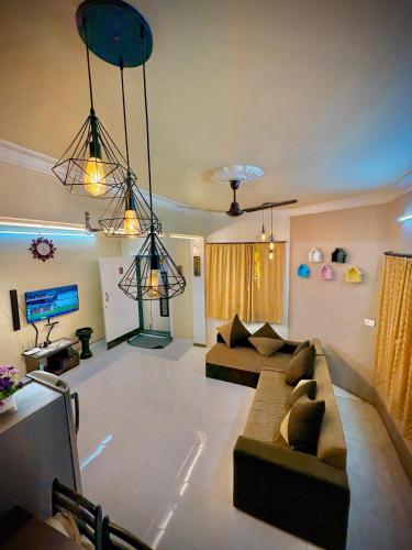 a living room with two couches and a tv at Swaransh villa in Lonavala