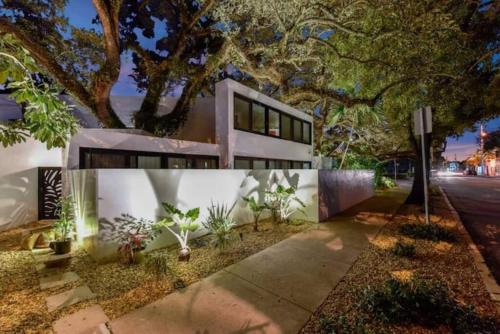 a house with a tree in front of it at Las Olas Hammocks Unit 2 By Pmi in Fort Lauderdale