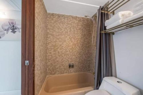 a bathroom with a toilet and a sink and a tub at Las Olas Hammocks Unit 2 By Pmi in Fort Lauderdale