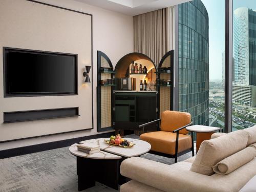a living room with a couch and a tv at Anantara Downtown Dubai in Dubai