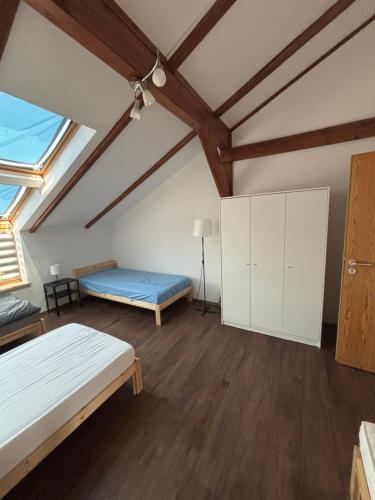 a attic room with two beds and a blue mattress at Wohnung mit Galerie in Prenzlau