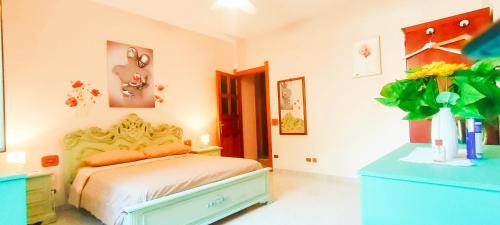 a bedroom with a bed and a blue dresser at Camera a Catanzaro in villa relax ""oasi verde"" in Catanzaro