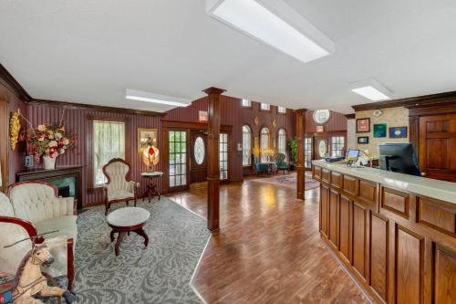 a large living room with wood paneling and a fireplace at Quality Inn Eureka Springs South in Eureka Springs