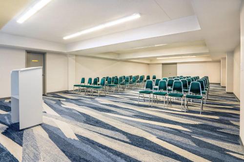 an empty conference room with chairs and a whiteboard at Comfort Inn & Suites in Barrie