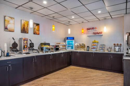 a kitchen with black cabinets and a counter top at Comfort Inn & Suites in Barrie