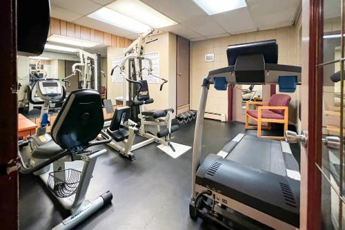 a gym with tread machines and a treadmill at Econo Lodge Motel Village in Calgary