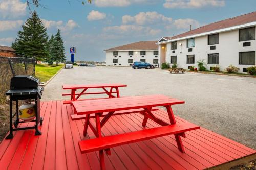 two picnic tables in a parking lot next to a building at Comfort Inn & Suites in Barrie