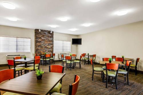 a dining room with tables and chairs and a tv at Quality Inn & Suites Vail Valley in Eagle