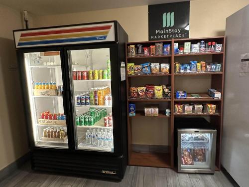 a refrigerator with its doors open in a store at MainStay Suites Coralville - Iowa City in Coralville
