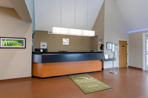 a waiting room with a counter in a building at Sleep Inn & Suites Smyrna - Nashville Area in Smyrna
