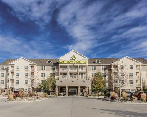 a hotel with a sign on the front of it at MainStay Suites Casper in Casper