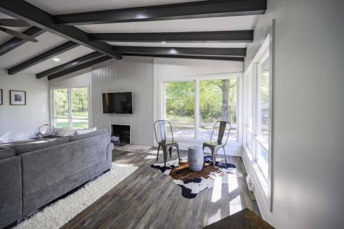 a living room with a gray couch and chairs at Gorgeous Renovated Home With Large & Private Lot in Winchester