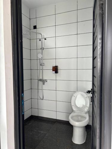 a bathroom with a shower and a toilet at Senara Resort Ciwidey in Baruhtunggul