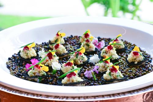 a white plate of food on a table at Bertam Wellness Spa & Villas - A Member of Small Luxury Hotels of the World in Kepala Batas