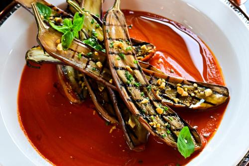 a plate of food with a bowl of sauce at Bertam Wellness Spa & Villas - A Member of Small Luxury Hotels of the World in Kepala Batas