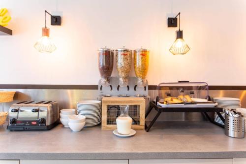 a kitchen with a counter top with some appliances at Clarion Aparthotel Toulouse Le Parc de l'Escale in Toulouse