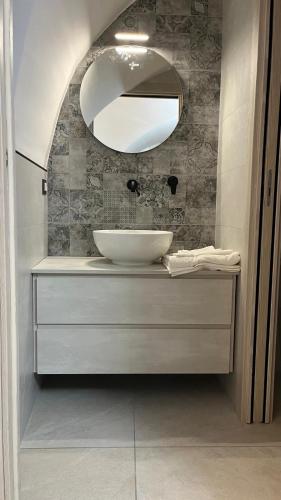 a bathroom with a white sink and a mirror at Il Duomo in Bovino