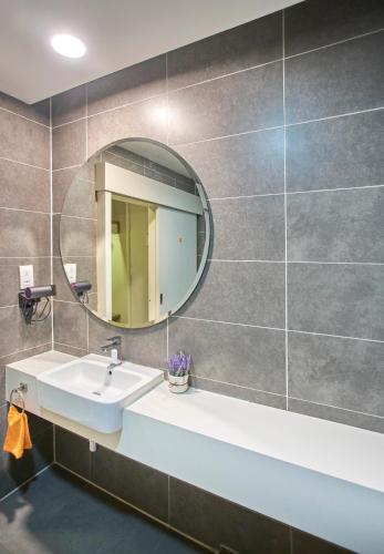 a bathroom with a sink and a mirror at Empire Damansara Petaling Jaya by COBNB in Petaling Jaya