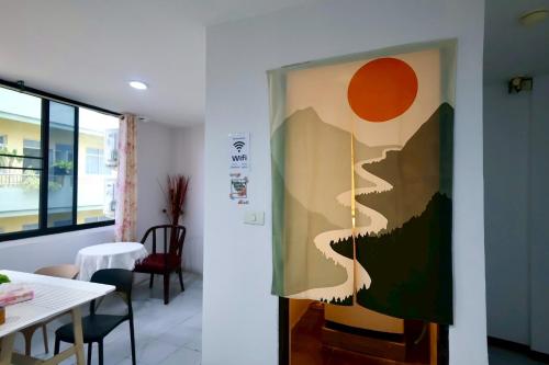 a painting of a man on a wall in a room at Sampheng House in Bangkok