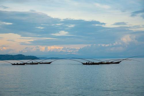 two boats in the water with nets in the water at Hakuna Matata Lodge in Gisenyi