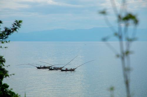 a group of people in a boat on the water at Hakuna Matata Lodge in Gisenyi