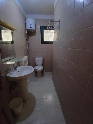 a bathroom with a sink and a toilet at Criss Naama bay in Sharm El Sheikh
