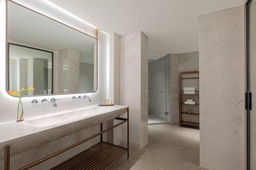 a bathroom with a sink and a mirror at Sunworld Dynasty Hotel Beijing Wangfujing in Beijing